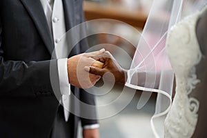 the groom holds the bride& x27;s hand