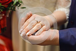 Groom holds the bride`s hand in his own