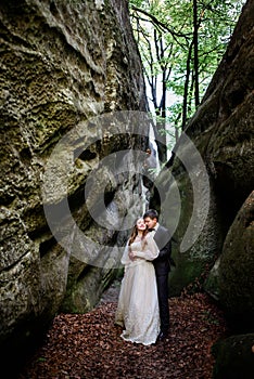 Groom kisses bride from behind