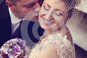 Groom kissing bride