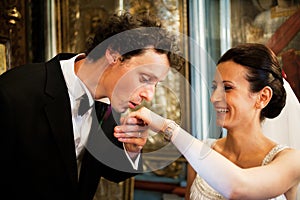 Groom kissing brides hand