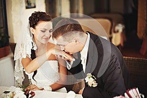 Groom kissing hand of his lovely bride