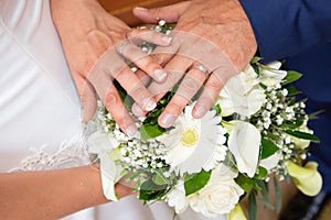 Groom man and bride woman hands with wedding rings