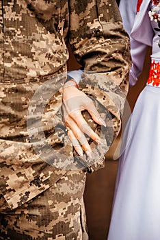 Groom in military uniform and bride