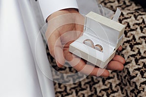 The groom offers to take a gold wedding ring to his bride