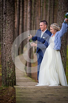 Groom openning the champagne at wedding day photo