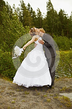 Groom passionately kisses bride