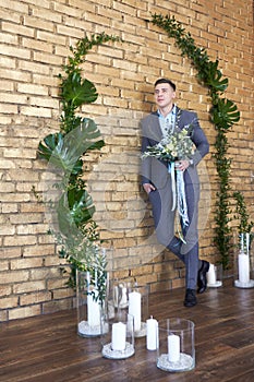 Groom preparing for the wedding. Future husband is waiting for his future wife.A man in a wedding suit poses for the photographer