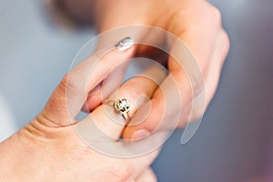 Groom put engagement ring on his bride finger. Jewellery diamond ring in husband to be hands. He put wedding ring on her finger.