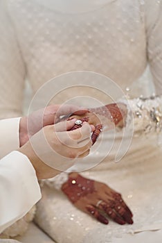 The groom put on the ring on the bride`s finger