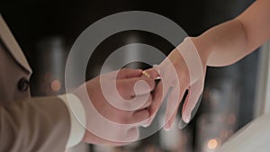 Groom puts the wedding ring on Bride`s finger. Marriage, hands with rings. The bride and groom exchange wedding rings.