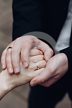 The groom puts a wedding ring on the bride`s finger. Wedding ceremony. The concept of love