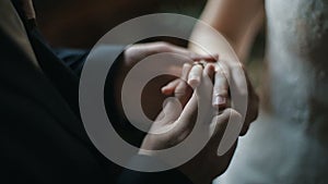 The groom puts the wedding ring on finger of the bride. marriage hands with rings. The bride and groom exchange wedding