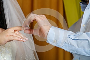 The groom putting the bride on the index finger at a Jewish wedding close-up.