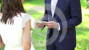 The groom reads the wedding vow to the bride during the ceremony