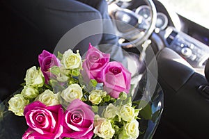 Groom rides for the uncountable with a huge bouquet of beautiful roses