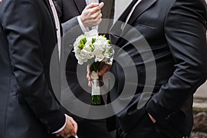Groom with ringers. Wedding bouquet before ceremony photo
