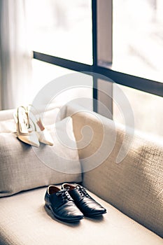 The groom's and Bried shoes against the window