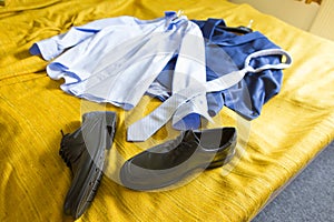 Groom`s cloths on a bed