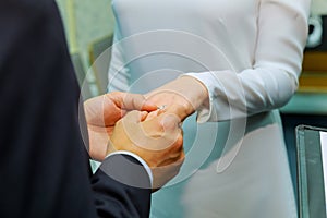 Groom`s hand putting wedding ring on the bride`s finger
