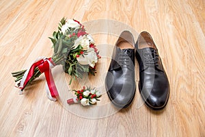 Groom's morning. Wedding accessories in red colors. Shoes, wedding bouquet, boutonniere on wooden background