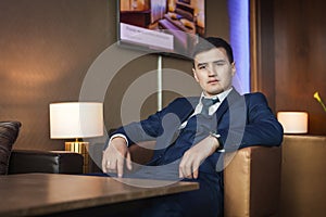 Groom sitting on the chair in hotel