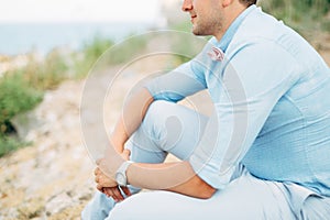 groom is sitting near the ancient abandoned Arza fortress on the Mamula island