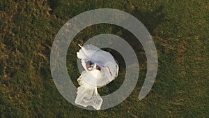 Groom spining around with his wife in hands