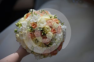 The groom in a suit or Young girl-bride or bridesmaid is holding a wedding bouquet