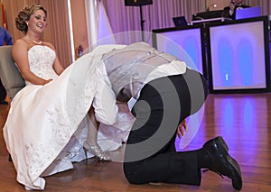 Groom taking off garter