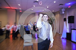 Groom tossing garter