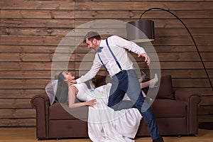 Groom trying to choke bride in white dress