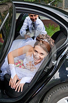 Groom trying to drag the bride out of the car