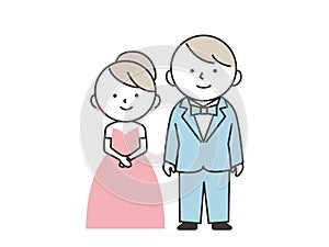 Groom in tuxedo and bride in pink dress standing side by side