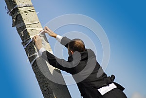 Groom tying tape to post