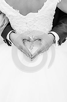 The groom was wrapped in the bride,  groom`s hands had a heart