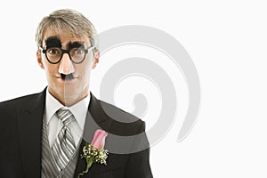 Groom wearing groucho glasses.