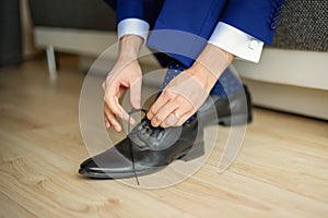 Groom is wearing shoes in blue wedding suit
