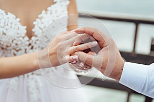 The groom wears the bride a wedding ring at the ceremony