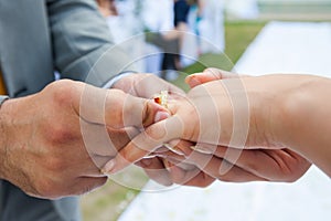 The groom wears the ring bride.