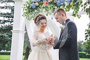 Groom wears a ring on the hand of the bride on wedding ceremony