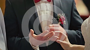 Groom Wears Wedding Ring on Woman`s Hand Bride Ceremony