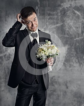 Groom with wedding flowers bouquet