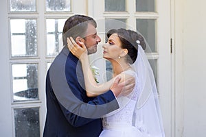 Groom in white shirt kissing bride hand. Very gentle photo