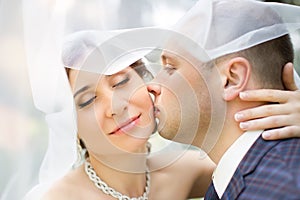 Groom in white shirt kissing bride hand. Very gentle photo