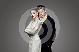 Groom in yellow bow-tie with bride, studio