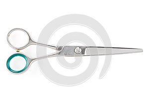 Grooming scissors. Scissors for cutting people and pets. Closed scissors on a white isolated background. Close-up