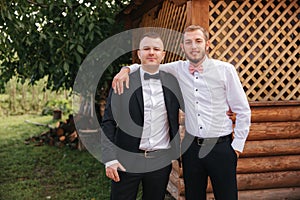 Groomsman spend time with groom at the backyard. Guys laugh and have fun