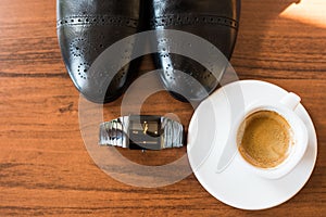 Groomâ€™s accessories: black shoes, watch, coffee