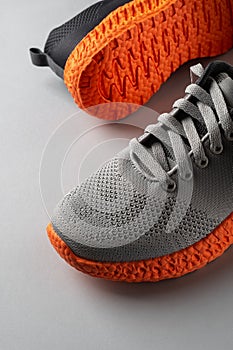 Grooved orange sole sneakers with gray elastic laces